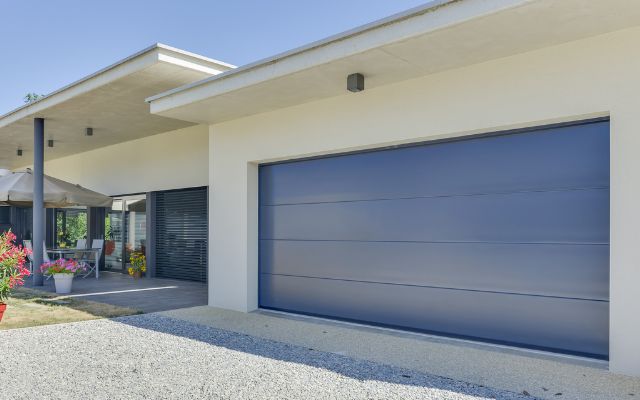 Porte de garage sectionnelle Carsec Pro en coloris Bleu Distant (RAL 5023) - Crédit photo : Soprofen